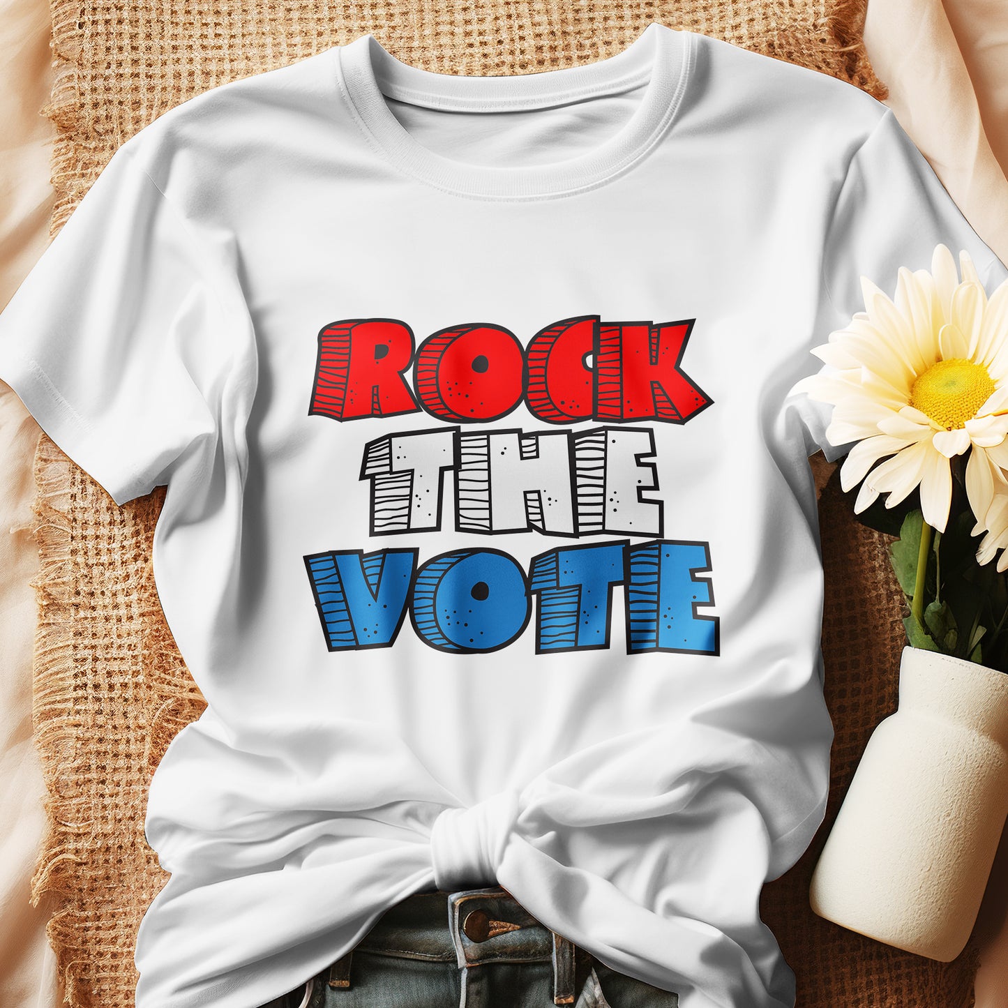 Rock The Vote T-Shirt with bold red, white, and blue lettering inspired by GenX style. The design features a retro, comic-style font with distressed detailing, representing a patriotic election theme. Available in unisex sizes and classic colors, perfect for showing civic pride and encouraging voter participation.