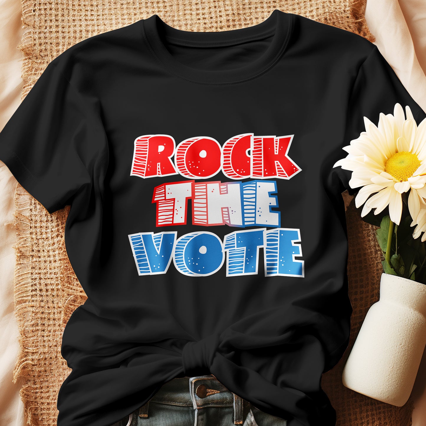 Rock The Vote T-Shirt with bold red, white, and blue lettering inspired by GenX style. The design features a retro, comic-style font with distressed detailing, representing a patriotic election theme. Available in unisex sizes and classic colors, perfect for showing civic pride and encouraging voter participation.