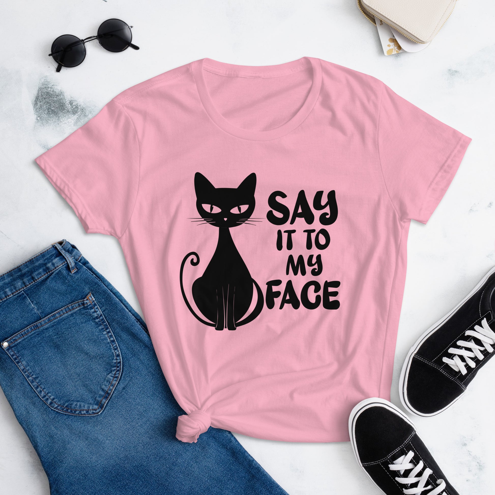 Charity Pink t-shirt featuring a black bold and sassy graphic of a cat with the words 'Say It To My Face,' representing confidence and attitude. Perfect for women who embrace their inner feline and want to make a statement with their fashion.