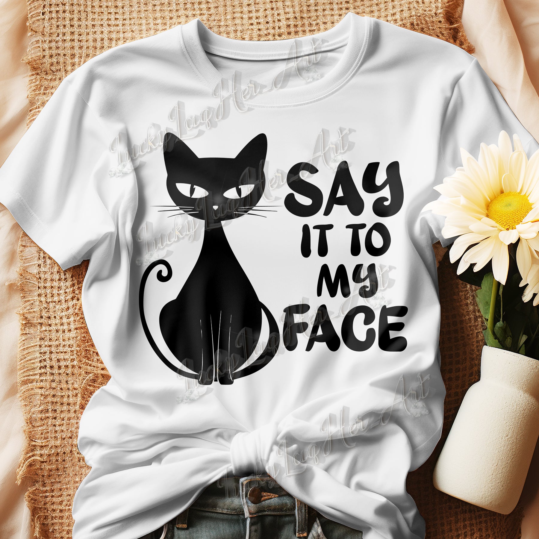 White t-shirt featuring a bold and sassy graphic of a cat with the words 'Say It To My Face,' representing confidence and attitude. Perfect for women who embrace their inner feline and want to make a statement with their fashion.