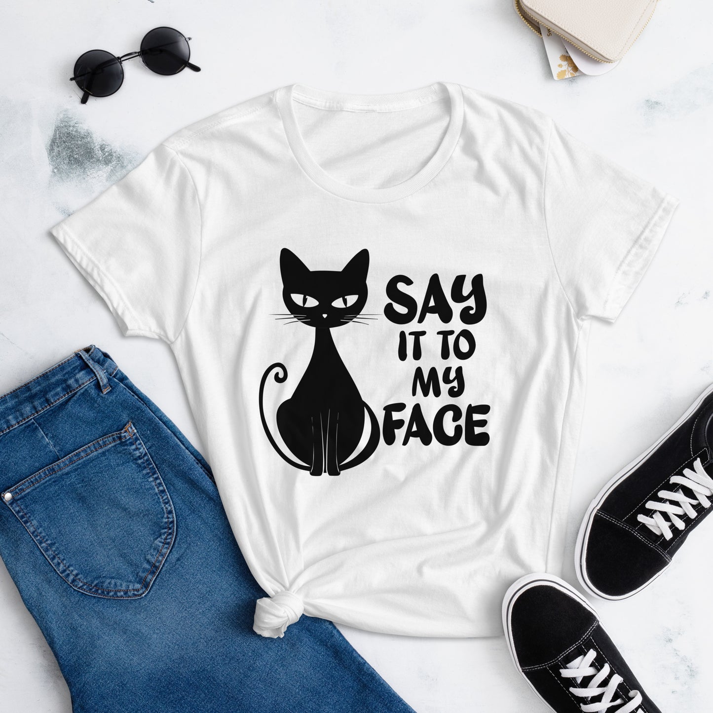 White t-shirt featuring a black bold and sassy graphic of a cat with the words 'Say It To My Face,' representing confidence and attitude. Perfect for women who embrace their inner feline and want to make a statement with their fashion.