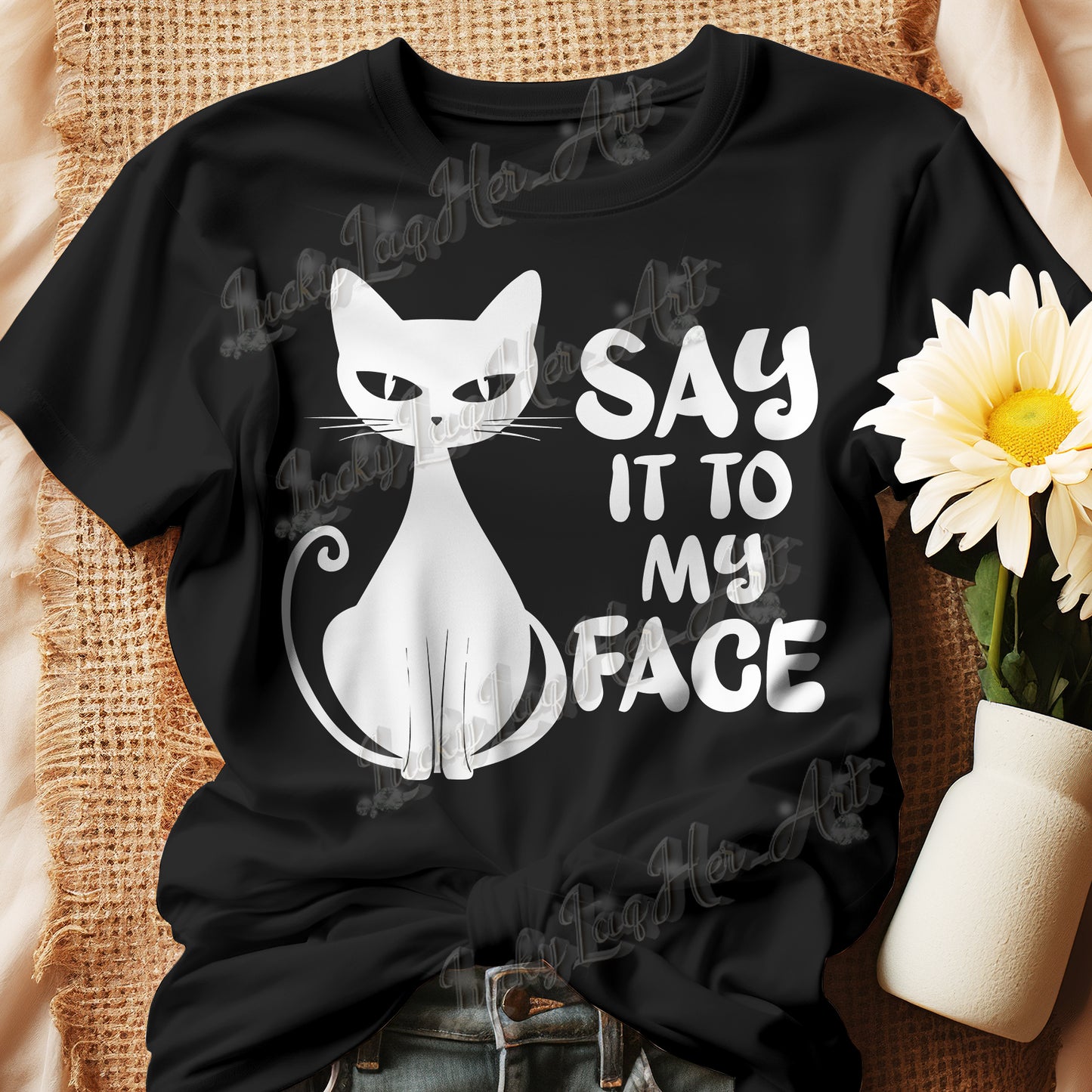 Black t-shirt featuring a white bold and sassy graphic of a cat with the words 'Say It To My Face,' representing confidence and attitude. Perfect for women who embrace their inner feline and want to make a statement with their fashion.