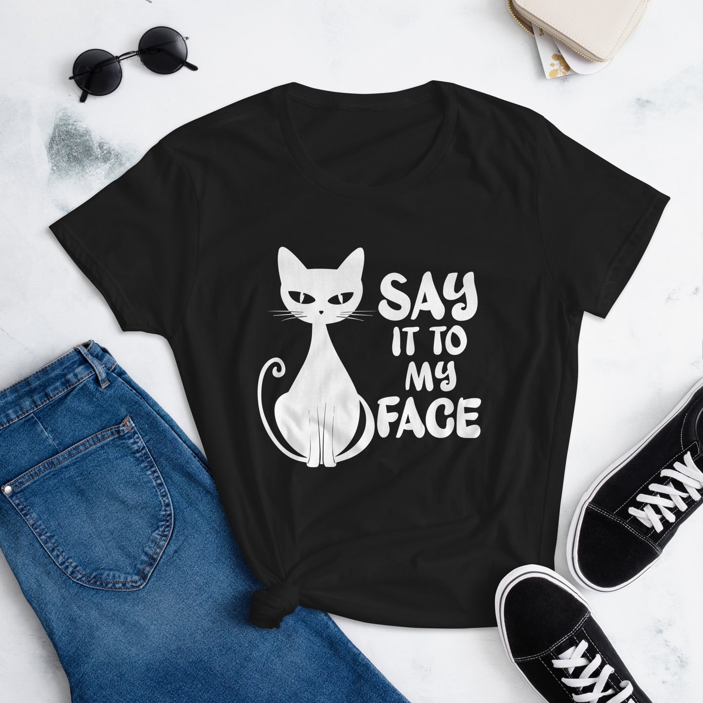 Black t-shirt featuring a white bold and sassy graphic of a cat with the words 'Say It To My Face,' representing confidence and attitude. Perfect for women who embrace their inner feline and want to make a statement with their fashion.