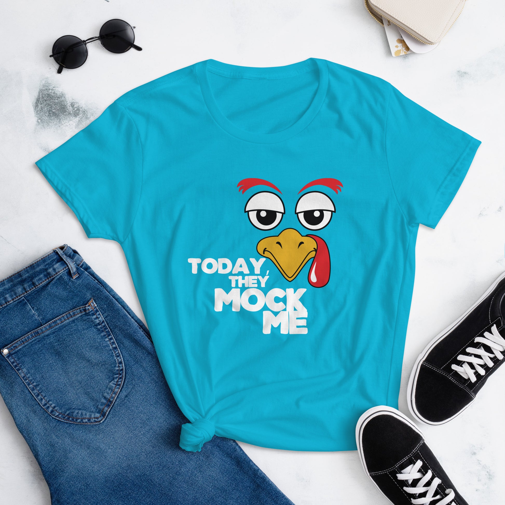 Caribbean Blue t-shirt with a humorous graphic of a turkey and the phrase 'Today They Mock Me' in bold white text. The bird has an expressive face with its tongue out, adding a playful and comedic touch to the design.