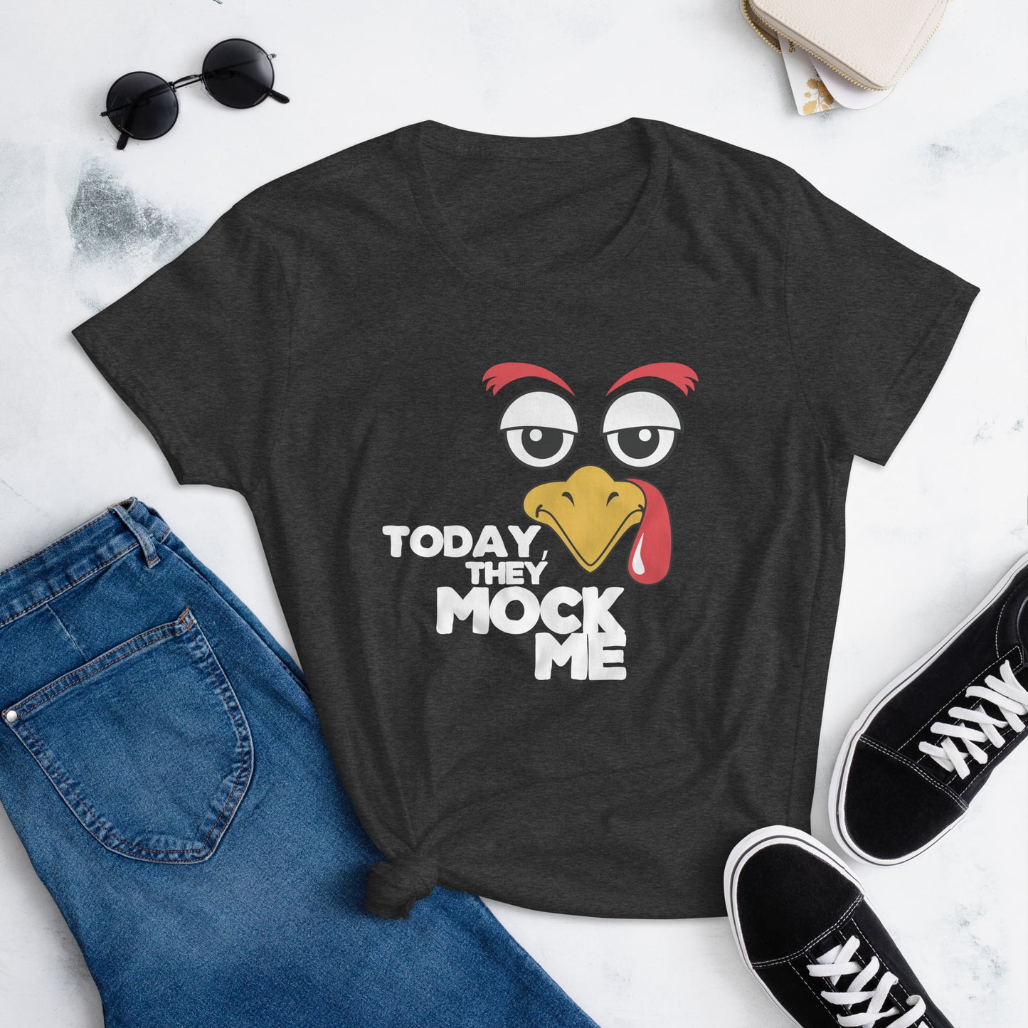 Black t-shirt with a humorous graphic of a turkey and the phrase 'Today They Mock Me' in bold white text. The bird has an expressive face with its tongue out, adding a playful and comedic touch to the design.