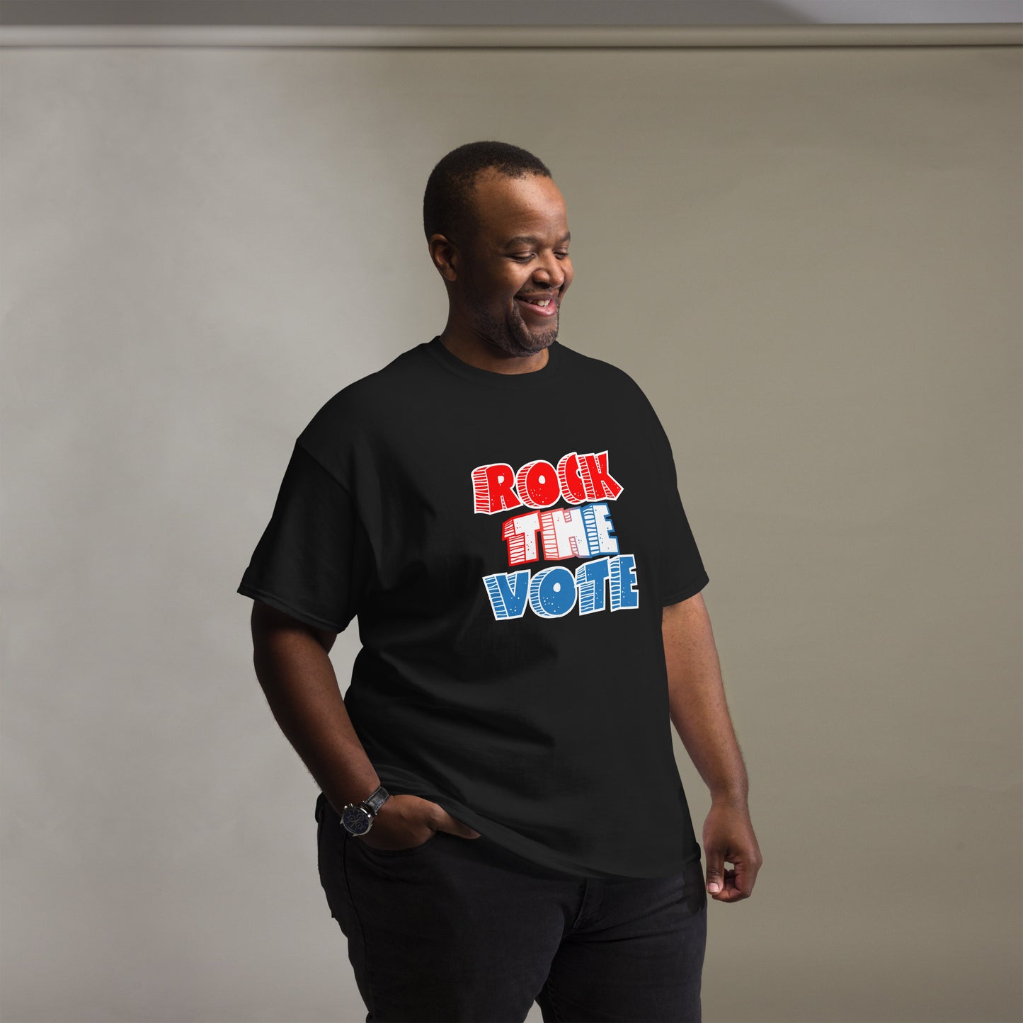 Rock The Vote T-Shirt with bold red, white, and blue lettering inspired by GenX style. The design features a retro, comic-style font with distressed detailing, representing a patriotic election theme. Available in unisex sizes and classic colors, perfect for showing civic pride and encouraging voter participation.