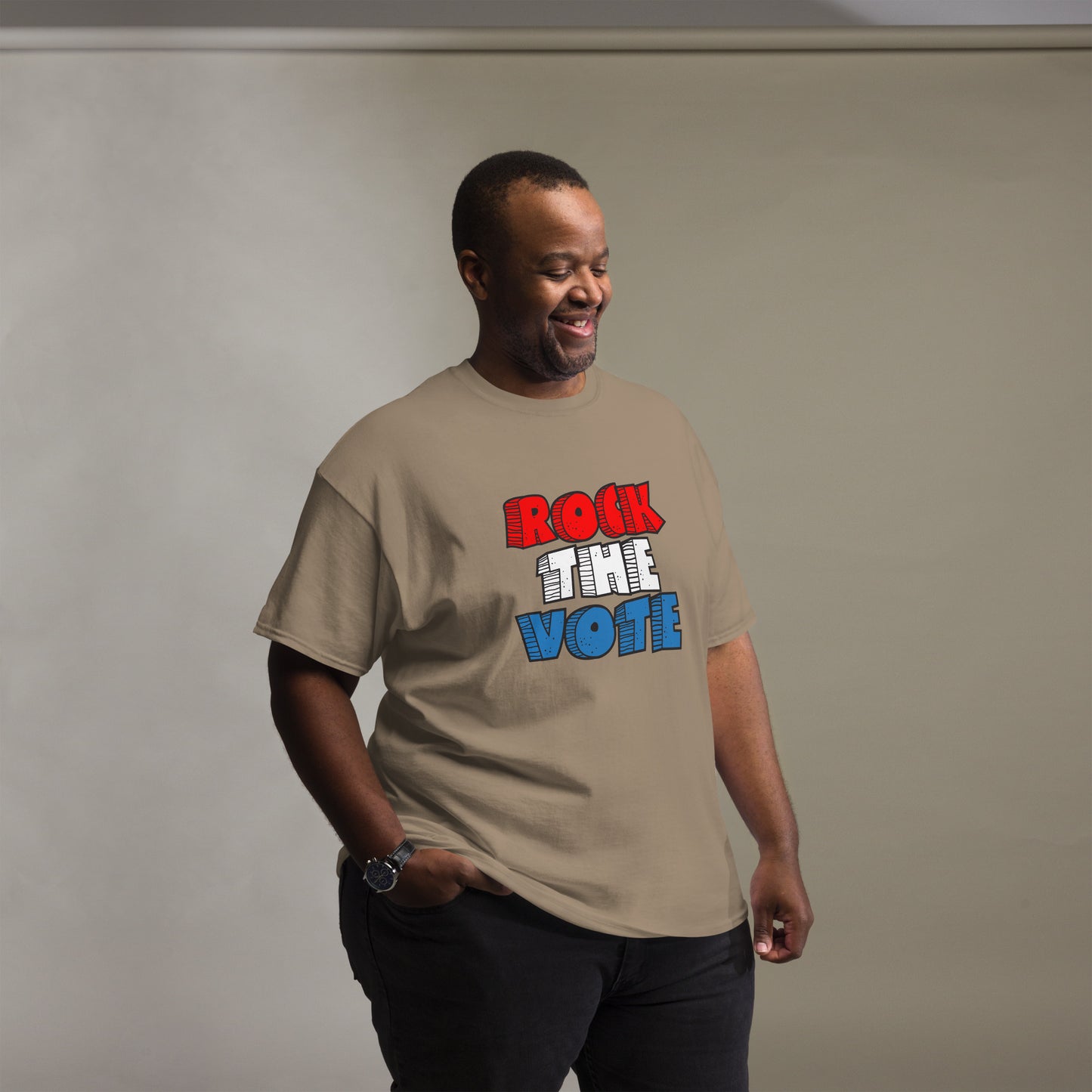 Rock The Vote T-Shirt with bold red, white, and blue lettering inspired by GenX style. The design features a retro, comic-style font with distressed detailing, representing a patriotic election theme. Available in unisex sizes and classic colors, perfect for showing civic pride and encouraging voter participation.