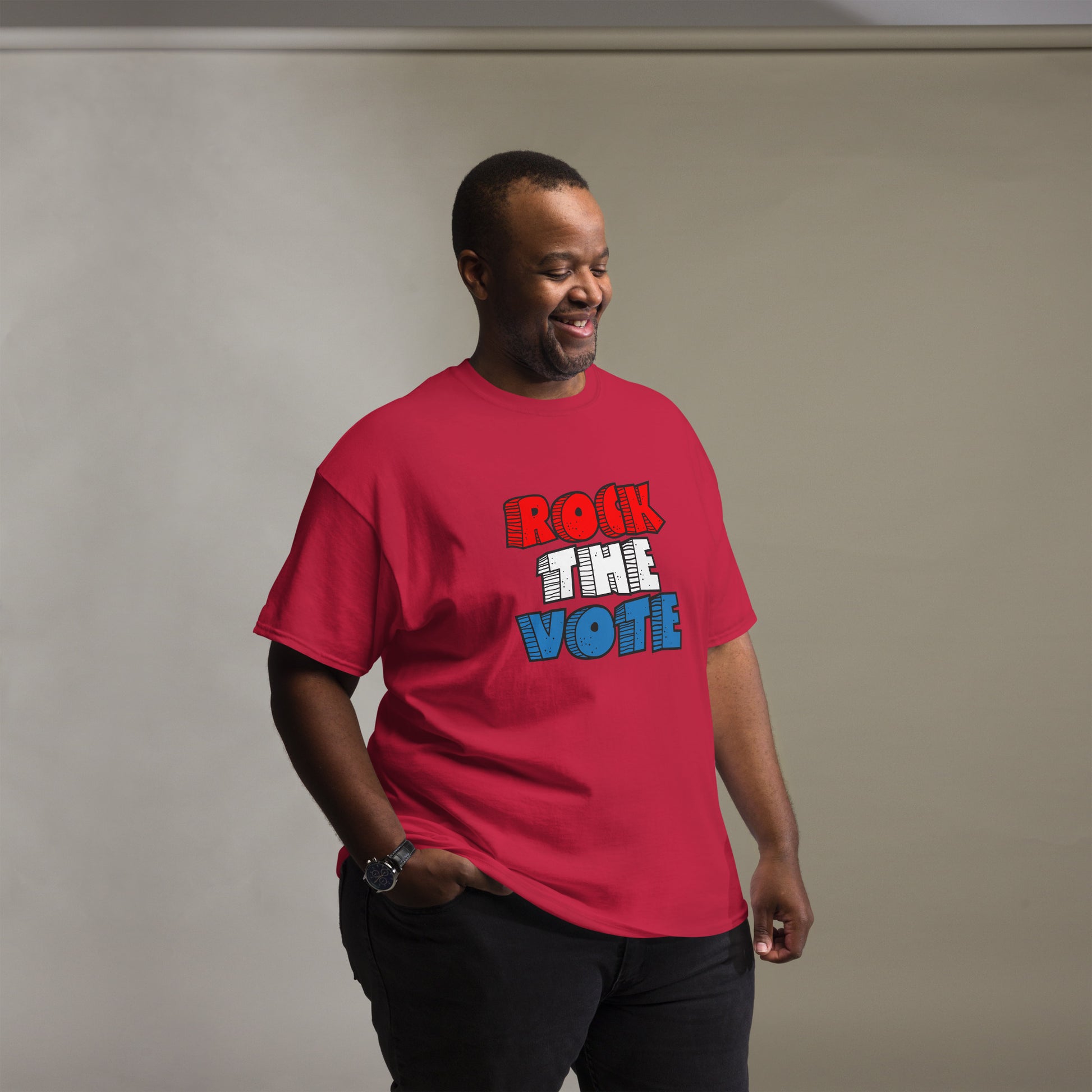 Rock The Vote T-Shirt with bold red, white, and blue lettering inspired by GenX style. The design features a retro, comic-style font with distressed detailing, representing a patriotic election theme. Available in unisex sizes and classic colors, perfect for showing civic pride and encouraging voter participation.