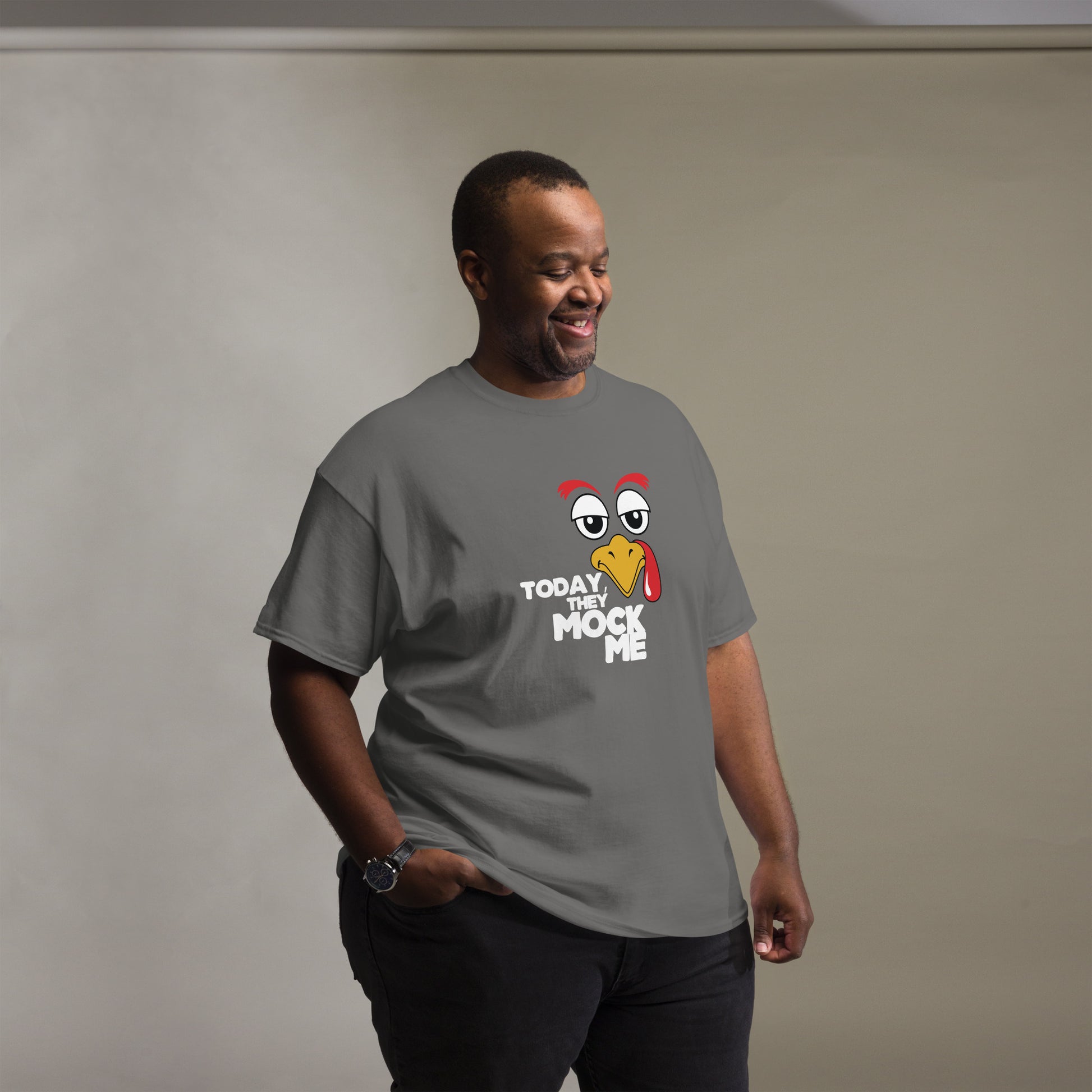 T-shirt with a humorous graphic of a Turkey face and the phrase 'Today They Mock Me' in bold white text. The bird has an expressive face with its tongue out, adding a playful and comedic touch to the design.