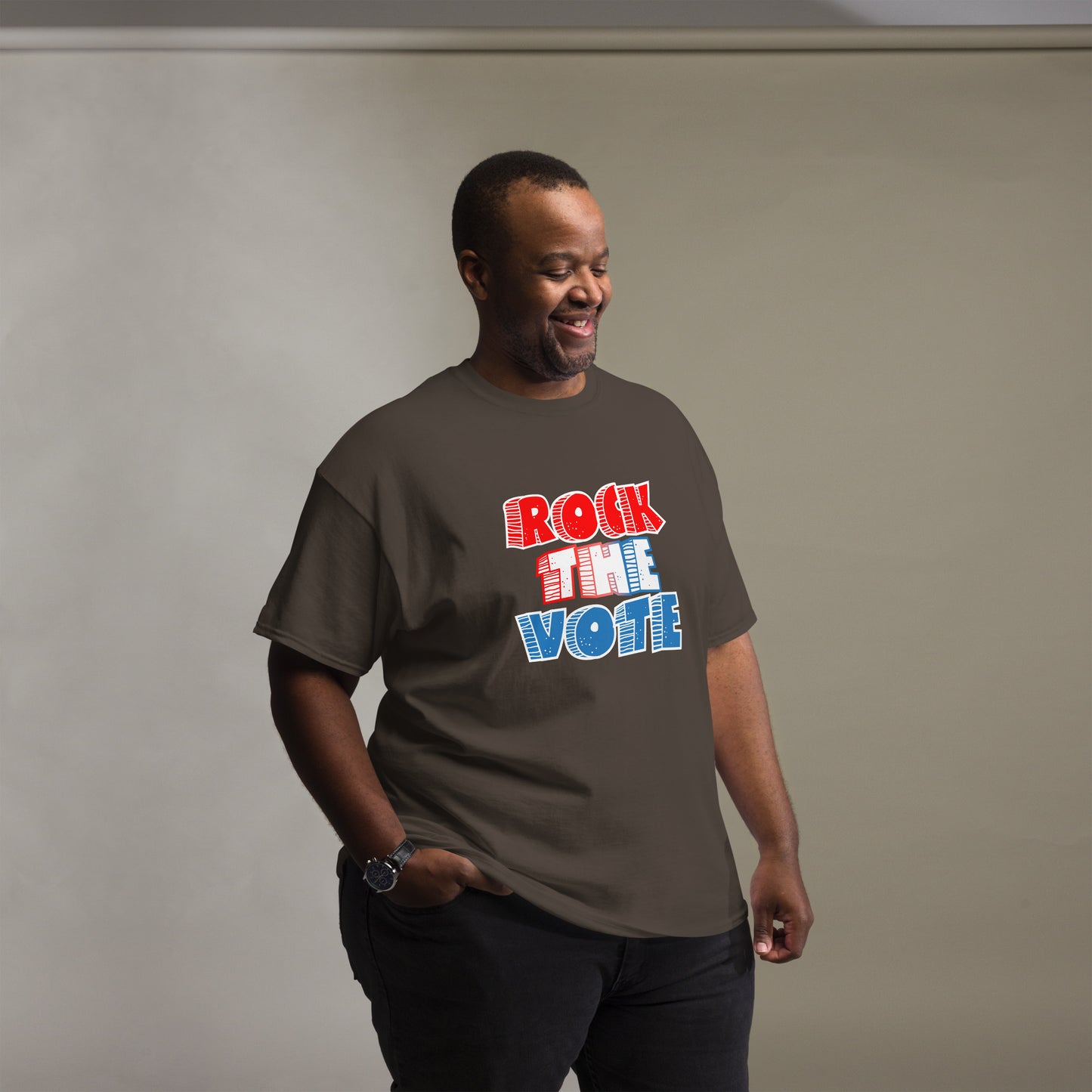 Rock The Vote T-Shirt with bold red, white, and blue lettering inspired by GenX style. The design features a retro, comic-style font with distressed detailing, representing a patriotic election theme. Available in unisex sizes and classic colors, perfect for showing civic pride and encouraging voter participation.