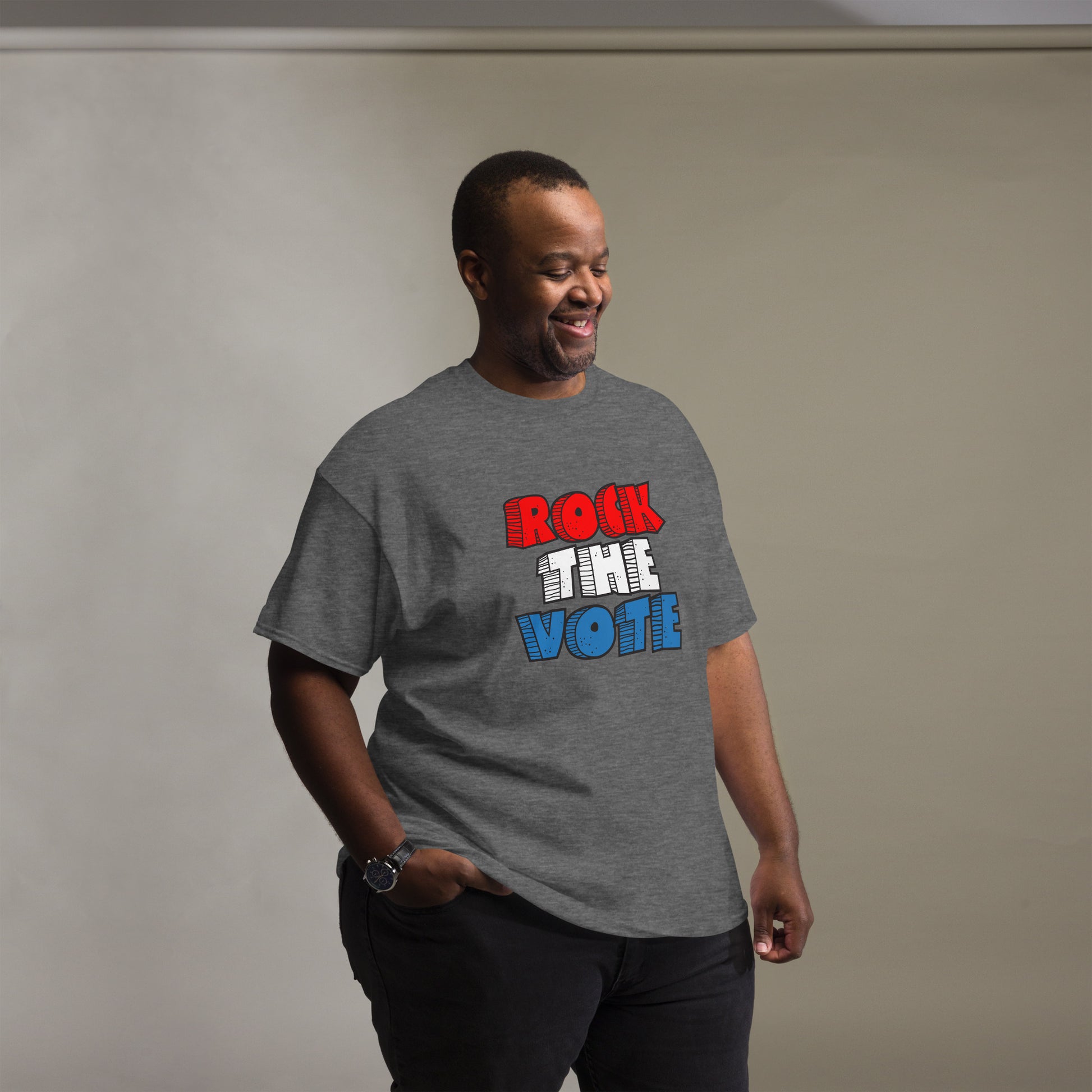 Rock The Vote T-Shirt with bold red, white, and blue lettering inspired by GenX style. The design features a retro, comic-style font with distressed detailing, representing a patriotic election theme. Available in unisex sizes and classic colors, perfect for showing civic pride and encouraging voter participation.