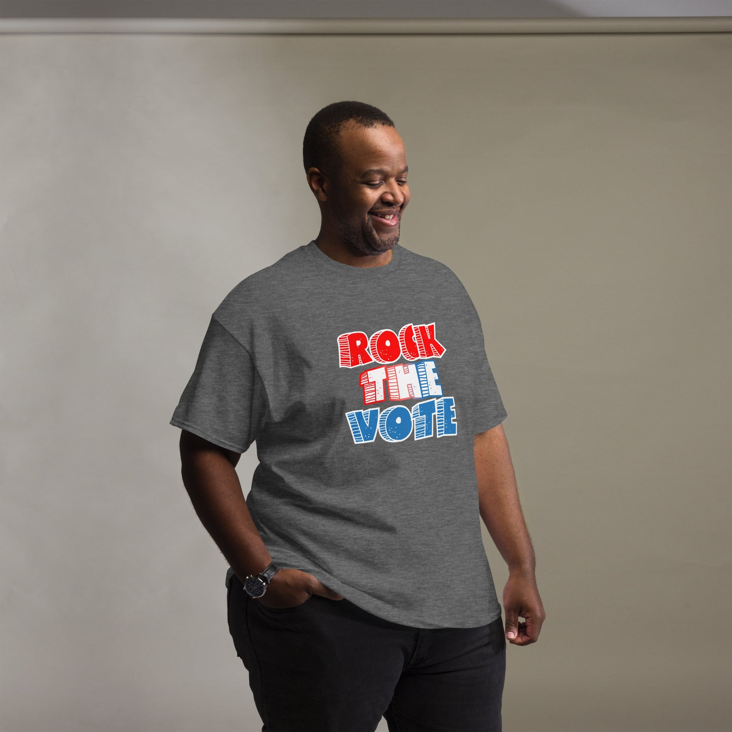 Rock The Vote T-Shirt with bold red, white, and blue lettering inspired by GenX style. The design features a retro, comic-style font with distressed detailing, representing a patriotic election theme. Available in unisex sizes and classic colors, perfect for showing civic pride and encouraging voter participation.