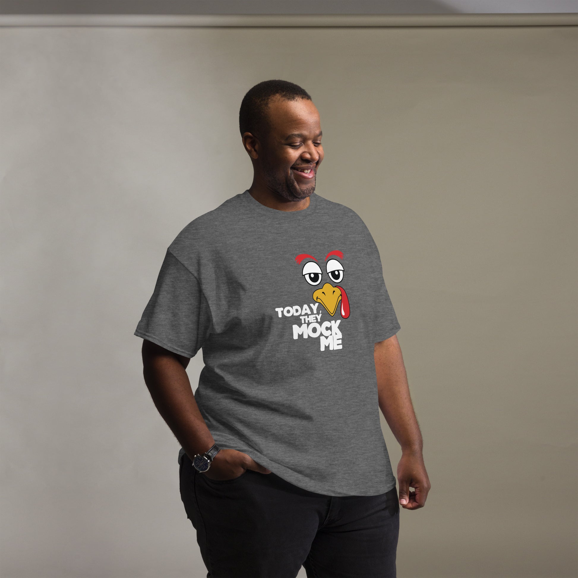 T-shirt with a humorous graphic of a Turkey face and the phrase 'Today They Mock Me' in bold white text. The bird has an expressive face with its tongue out, adding a playful and comedic touch to the design.