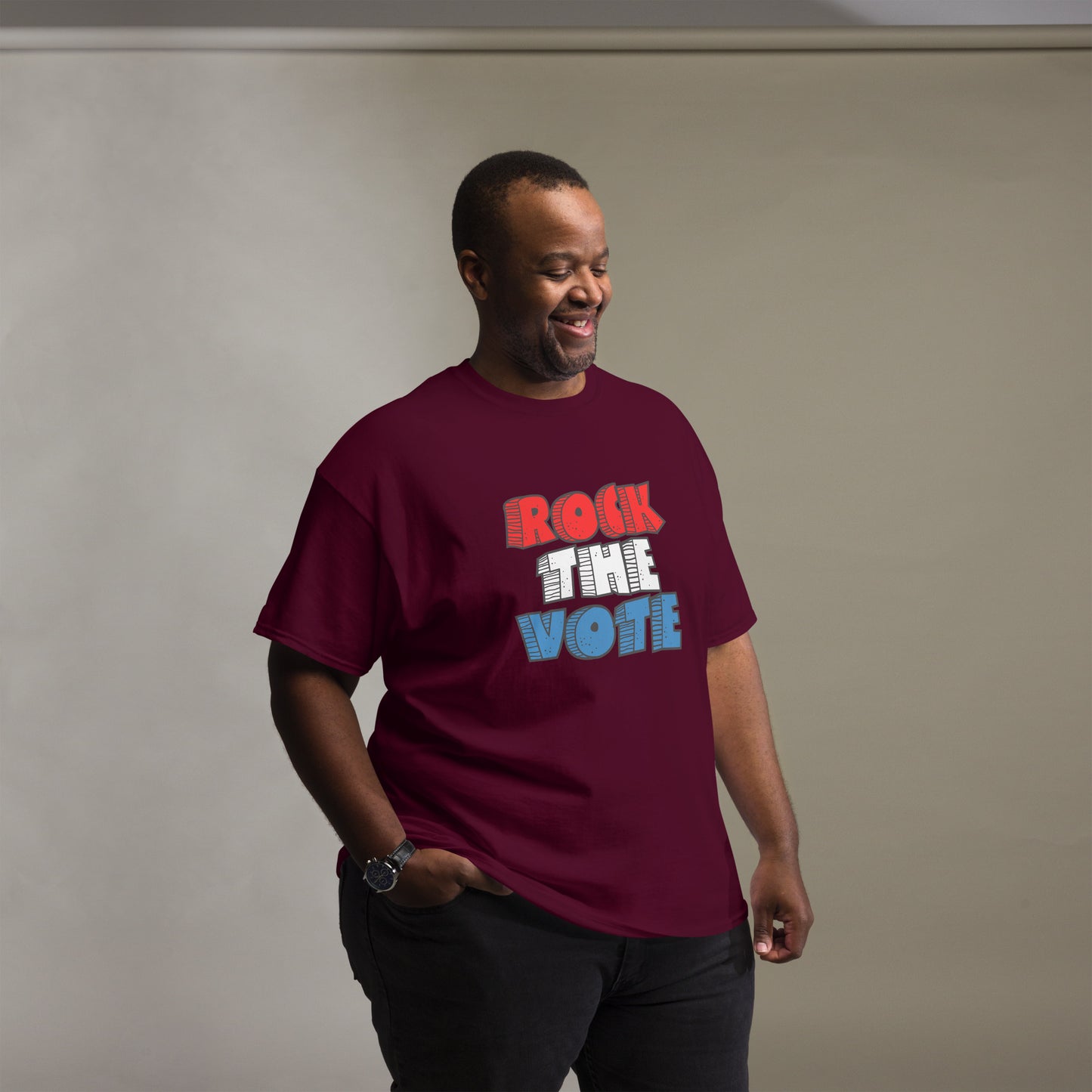 Rock The Vote T-Shirt with bold red, white, and blue lettering inspired by GenX style. The design features a retro, comic-style font with distressed detailing, representing a patriotic election theme. Available in unisex sizes and classic colors, perfect for showing civic pride and encouraging voter participation.