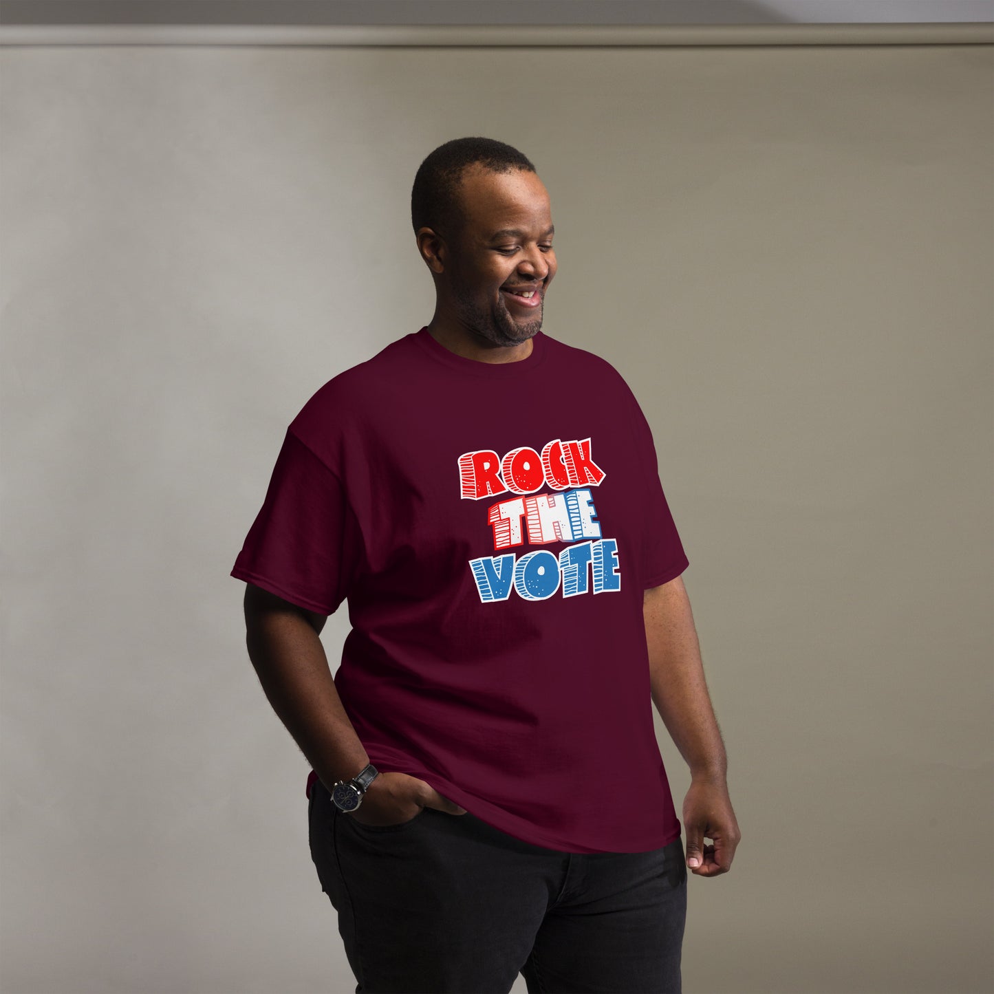 Rock The Vote T-Shirt with bold red, white, and blue lettering inspired by GenX style. The design features a retro, comic-style font with distressed detailing, representing a patriotic election theme. Available in unisex sizes and classic colors, perfect for showing civic pride and encouraging voter participation.