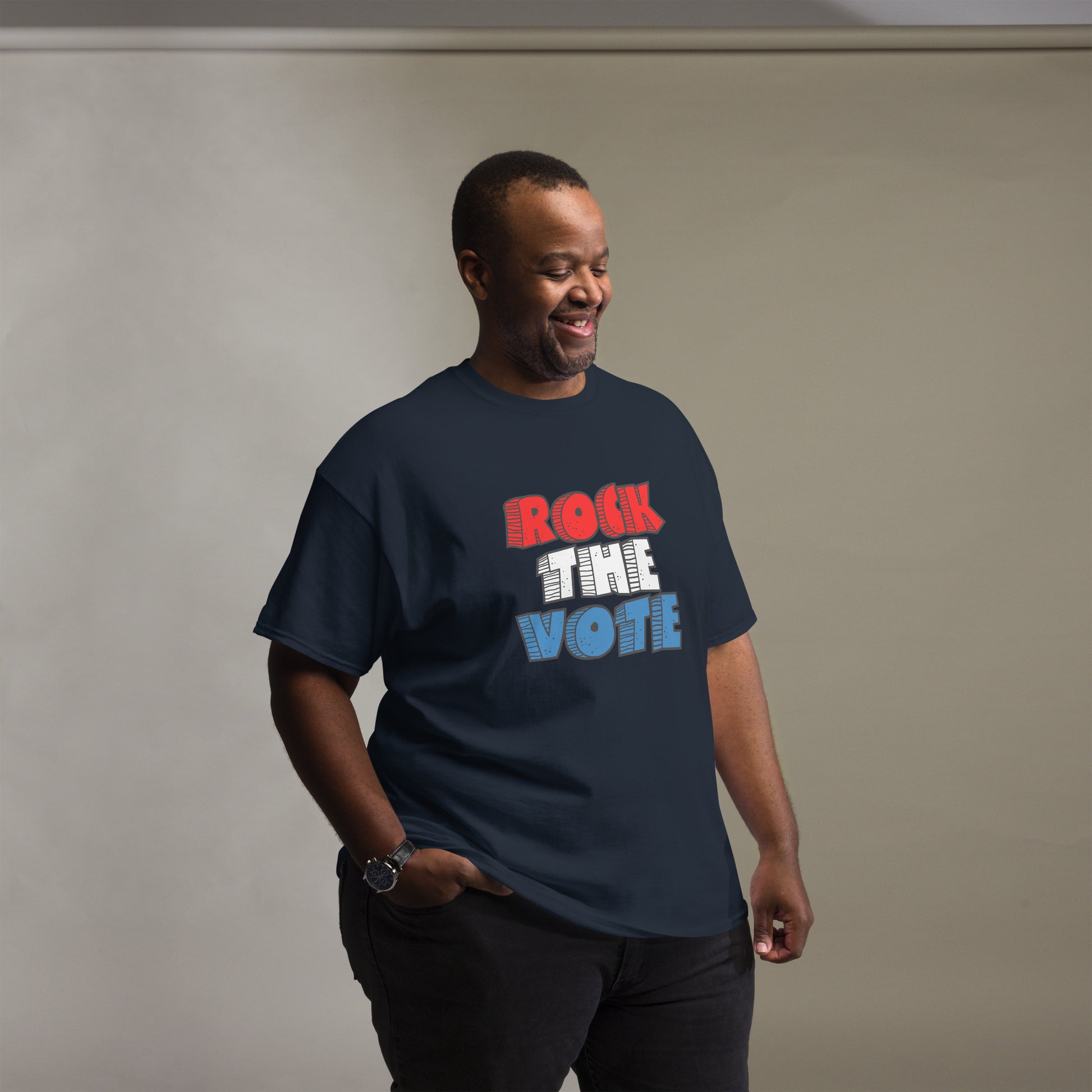 Rock The Vote T-Shirt with bold red, white, and blue lettering inspired by GenX style. The design features a retro, comic-style font with distressed detailing, representing a patriotic election theme. Available in unisex sizes and classic colors, perfect for showing civic pride and encouraging voter participation.