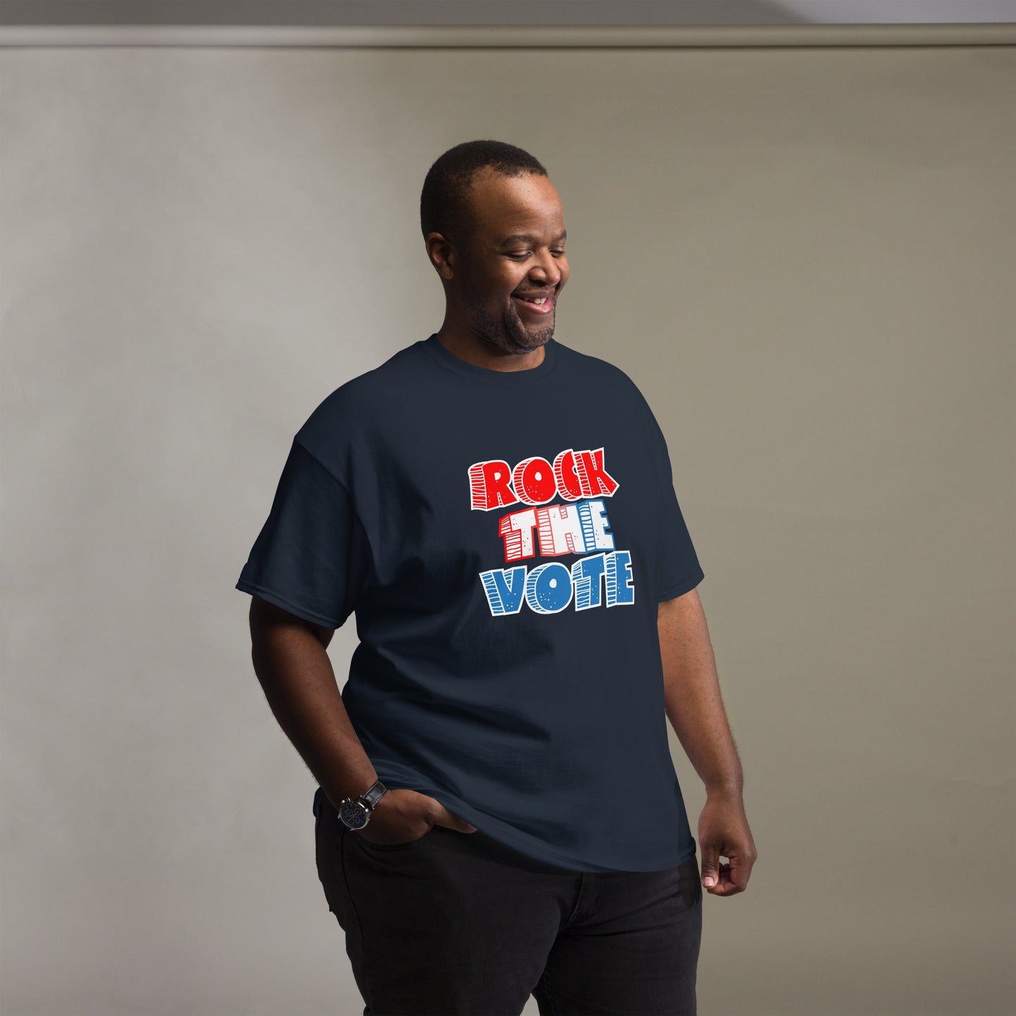 Rock The Vote T-Shirt with bold red, white, and blue lettering inspired by GenX style. The design features a retro, comic-style font with distressed detailing, representing a patriotic election theme. Available in unisex sizes and classic colors, perfect for showing civic pride and encouraging voter participation.