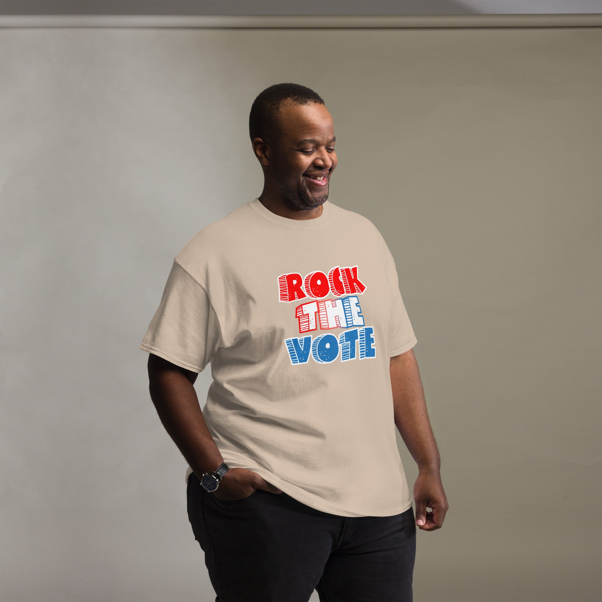 Rock The Vote T-Shirt with bold red, white, and blue lettering inspired by GenX style. The design features a retro, comic-style font with distressed detailing, representing a patriotic election theme. Available in unisex sizes and classic colors, perfect for showing civic pride and encouraging voter participation.