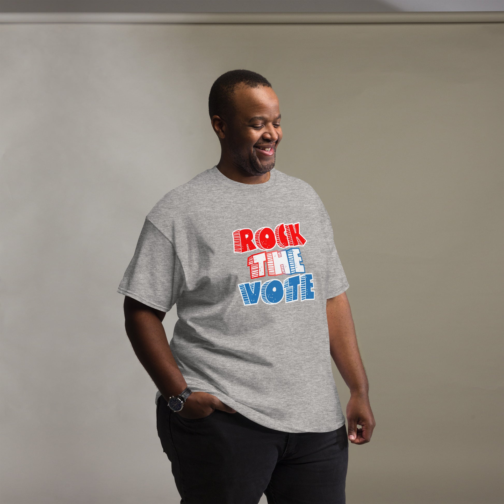 Rock The Vote T-Shirt with bold red, white, and blue lettering inspired by GenX style. The design features a retro, comic-style font with distressed detailing, representing a patriotic election theme. Available in unisex sizes and classic colors, perfect for showing civic pride and encouraging voter participation.