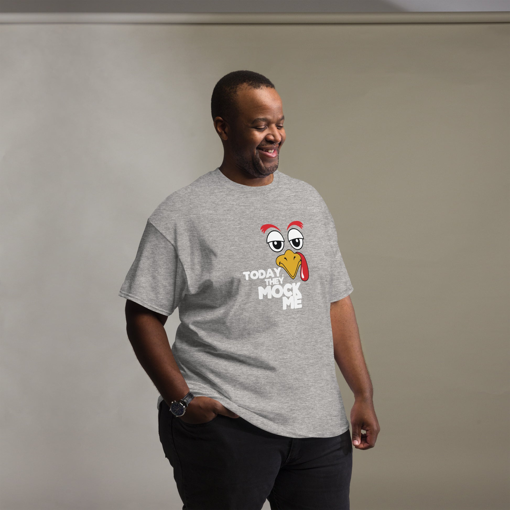 T-shirt with a humorous graphic of a Turkey face and the phrase 'Today They Mock Me' in bold white text. The bird has an expressive face with its tongue out, adding a playful and comedic touch to the design.