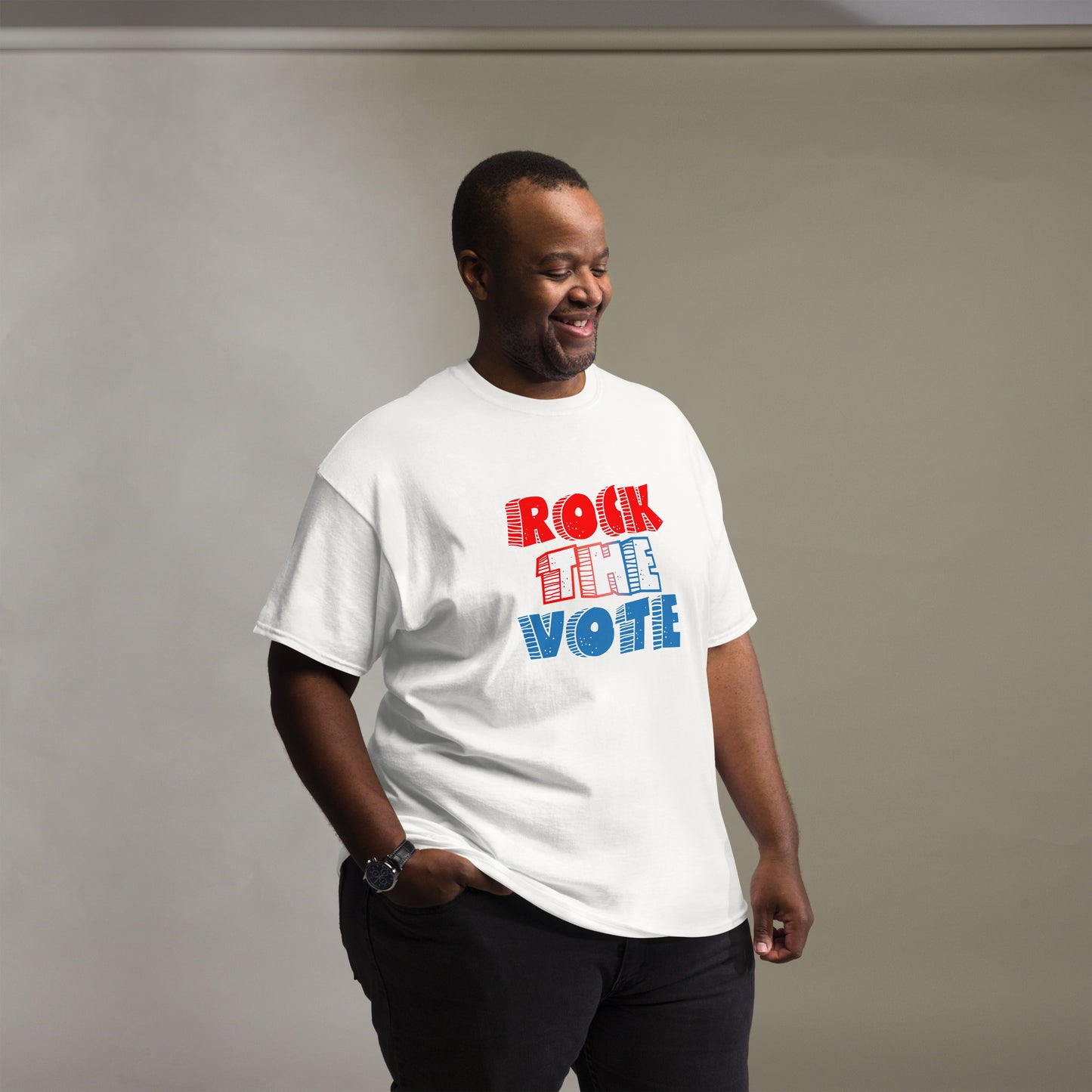 Rock The Vote T-Shirt with bold red, white, and blue lettering inspired by GenX style. The design features a retro, comic-style font with distressed detailing, representing a patriotic election theme. Available in unisex sizes and classic colors, perfect for showing civic pride and encouraging voter participation.