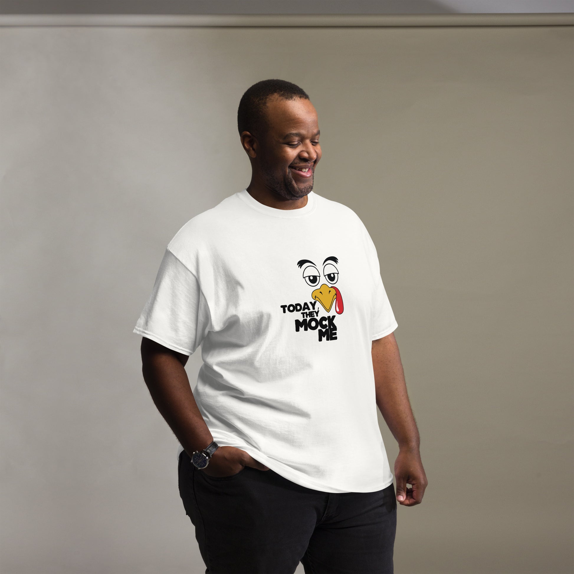 Black t-shirt with a humorous graphic of a mocking bird and the phrase 'Today They Mock Me' in bold white text. The bird has an expressive face with its tongue out, adding a playful and comedic touch to the design.