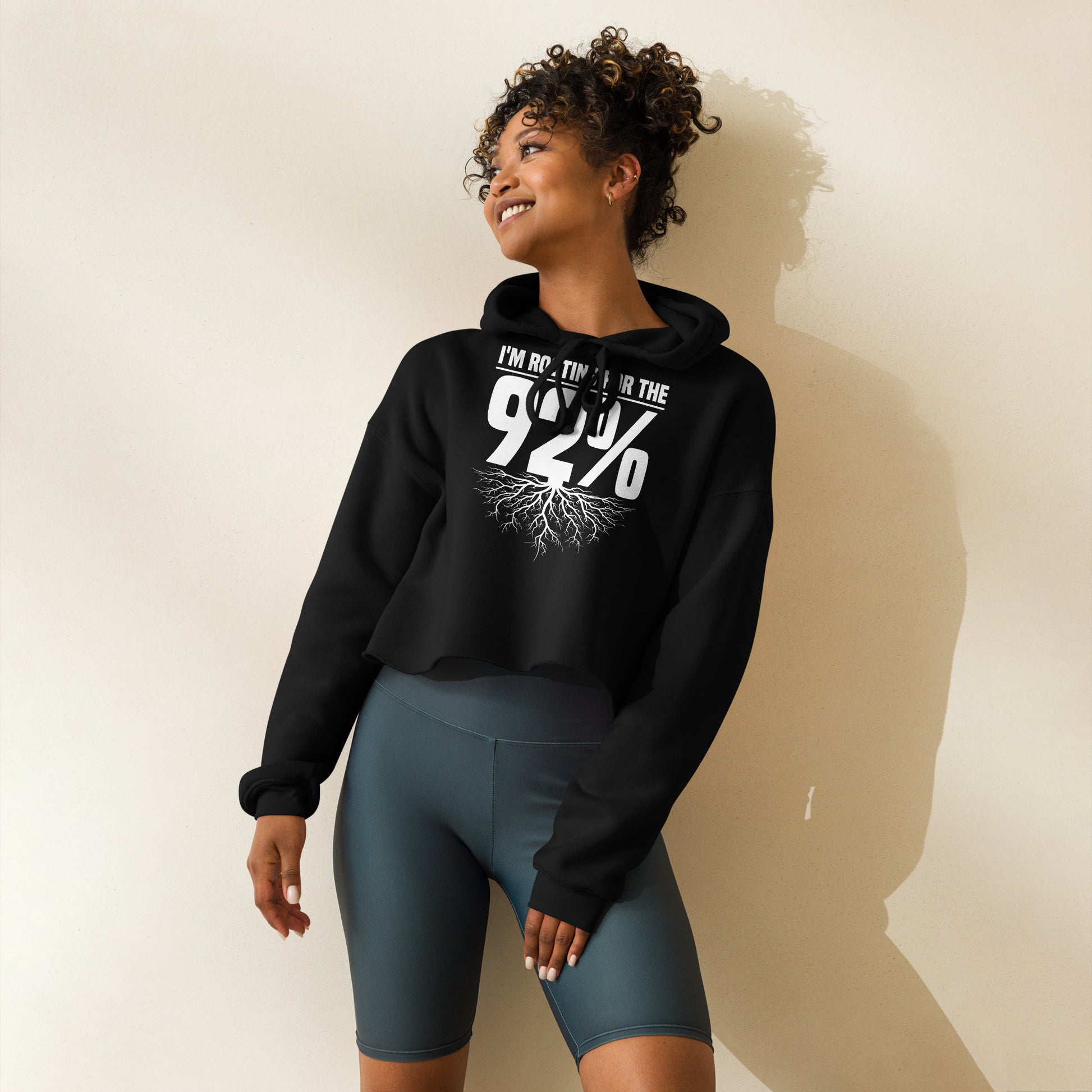 Black crop hoodie with bold white text that reads 'Rooting for the 92%' and a root graphic beneath, celebrating unity and empowerment.