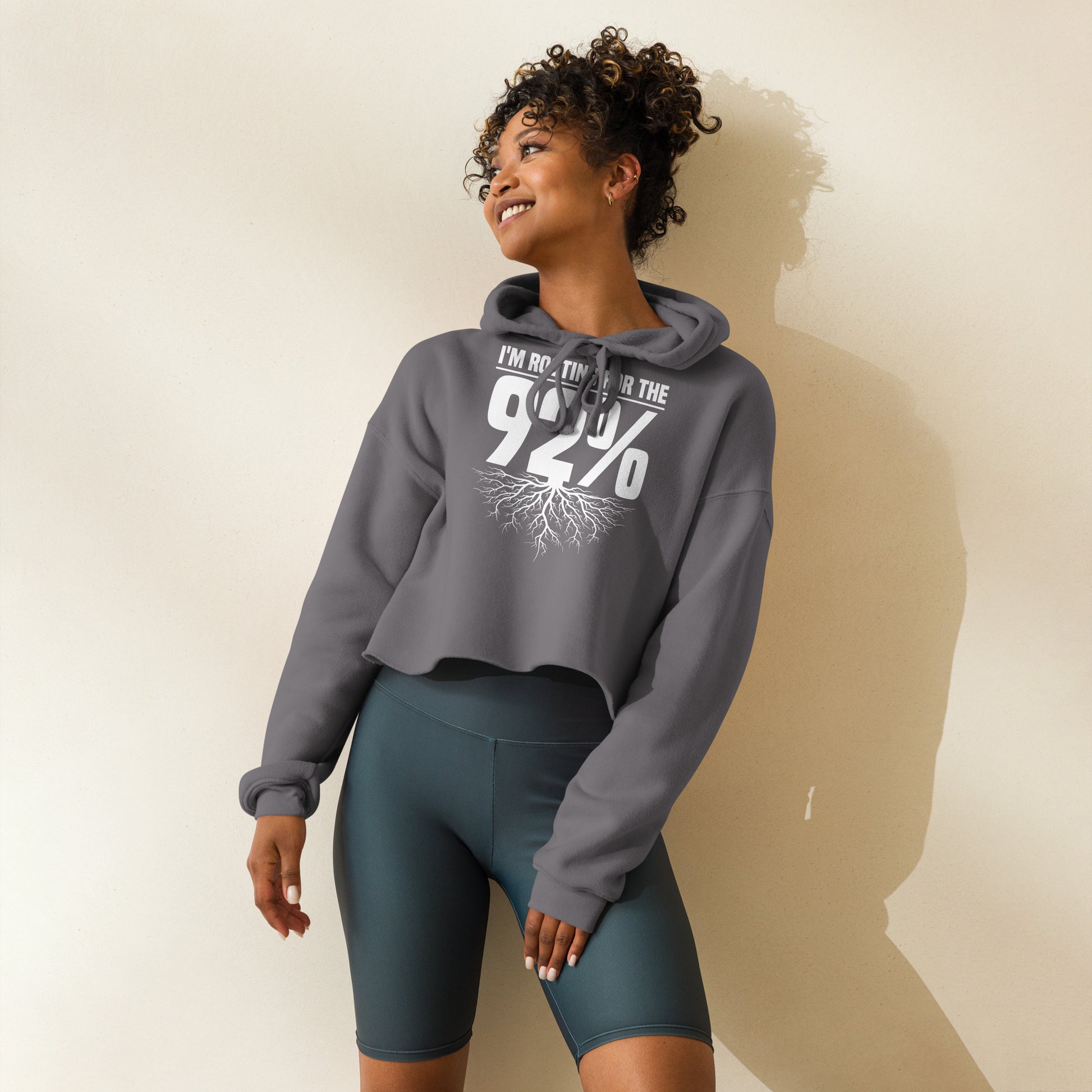 Black crop hoodie with bold white text that reads 'Rooting for the 92%' and a root graphic beneath, celebrating unity and empowerment.