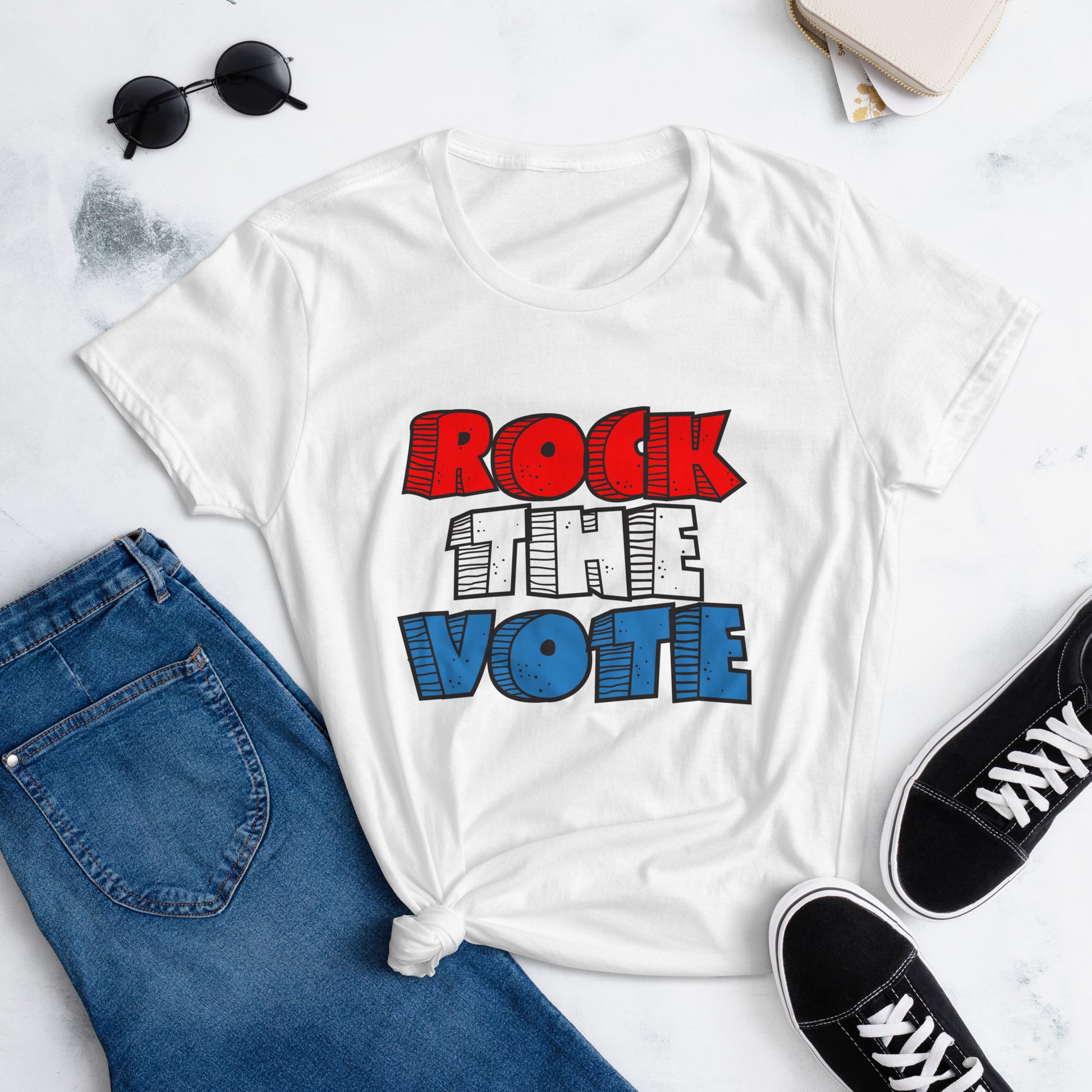 Rock The Vote T-Shirt with bold red, white, and blue lettering inspired by GenX style. The design features a retro, comic-style font with distressed detailing, representing a patriotic election theme. Available in unisex sizes and classic colors, perfect for showing civic pride and encouraging voter participation.